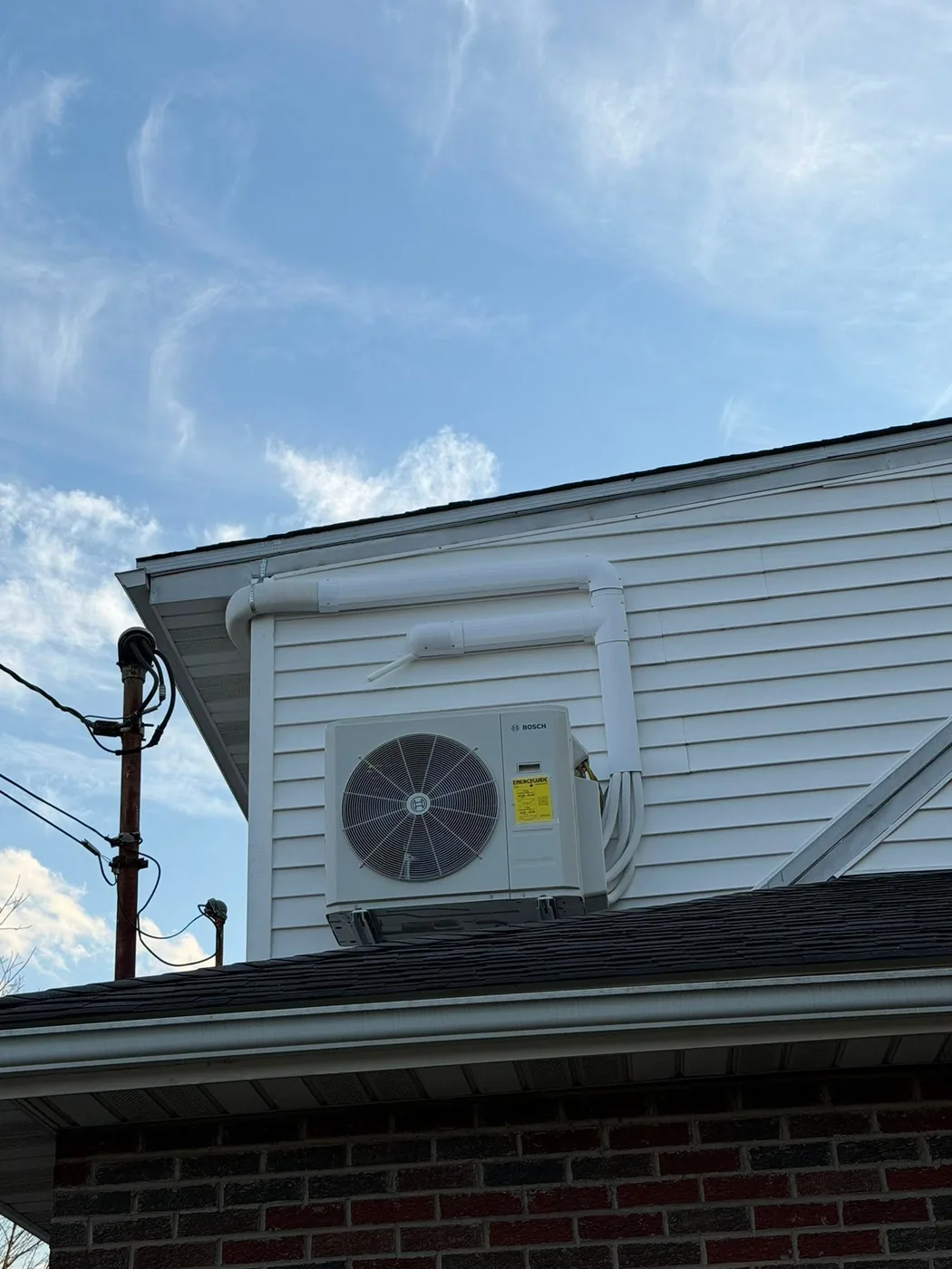 A house exterior and roofline against the sky