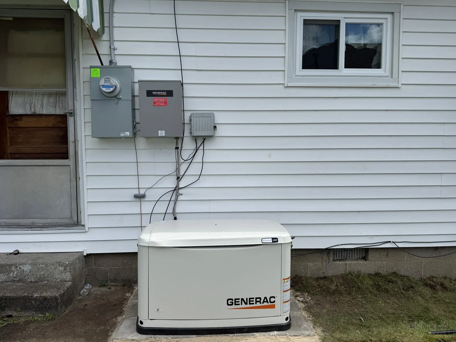A Generac standby generator installed beside a home