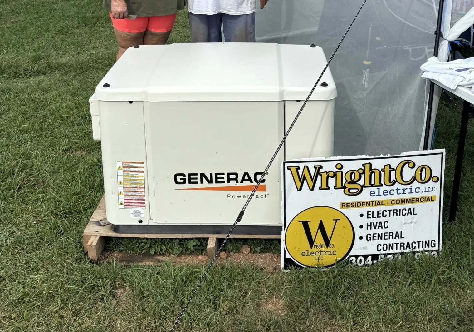 Generac generator on a pallet with a Wright Co Electric yard sign